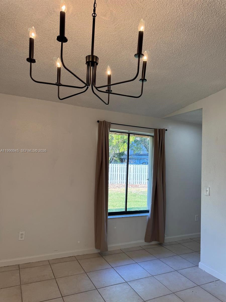 28002 Southwest 140th Court Homestead, FL 33033 - Photo 6 of 12 a view of an entryway with a window