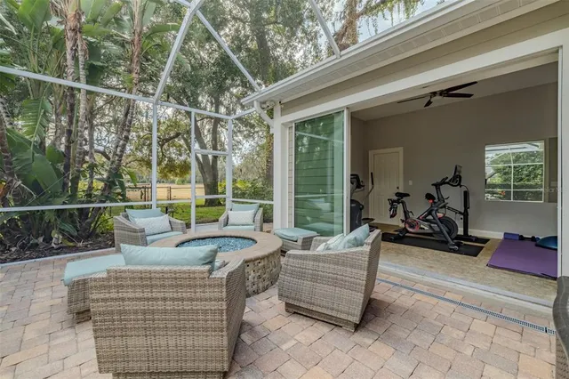 a dining room with wooden floor a chandelier a glass table and chairs