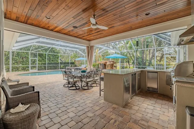 a kitchen with stainless steel appliances granite countertop sink stove top oven and refrigerator