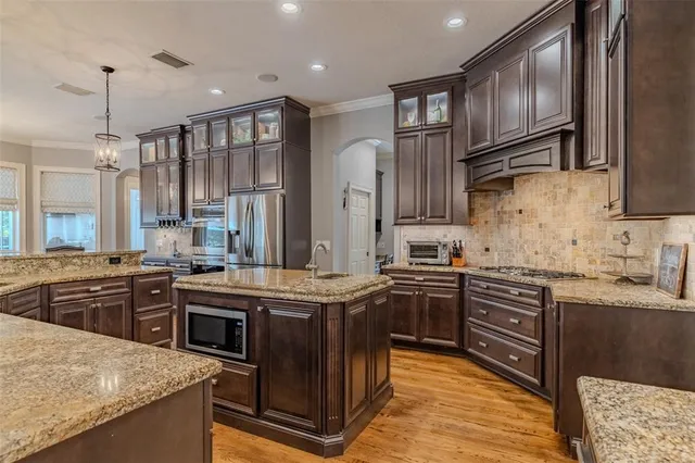 a large spacious bathroom with a granite countertop sink a bathtub and a mirror