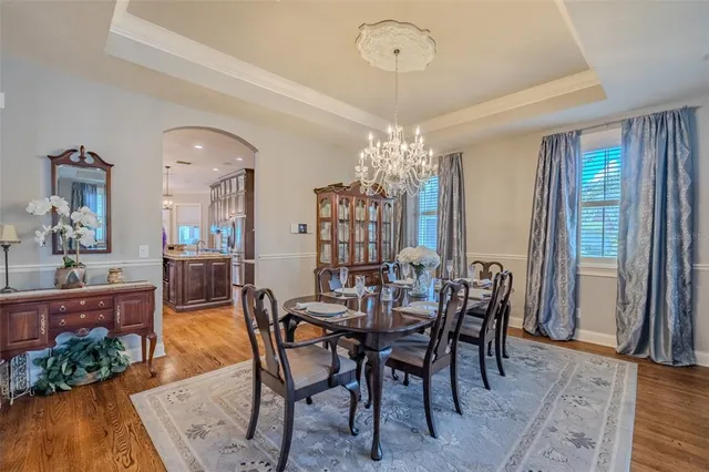 a kitchen with stainless steel appliances granite countertop a stove top oven a sink a refrigerator and cabinets