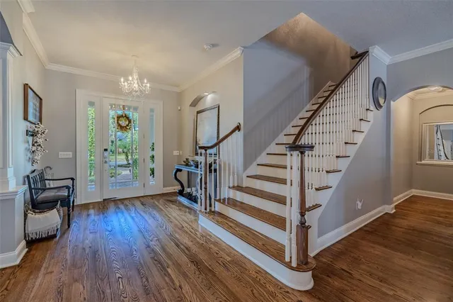 a view of entryway with wooden floor and stairs