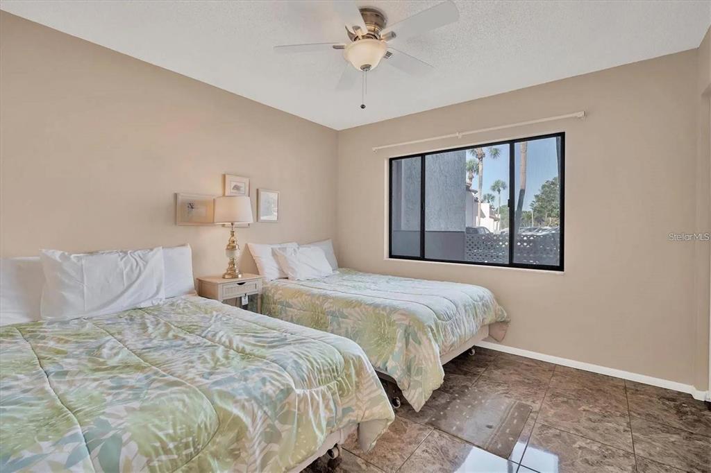 1624 Stickney Point Road, Unit 108 Sarasota, FL 34231 - Photo 11 of 39 a bedroom with double bed and a window
