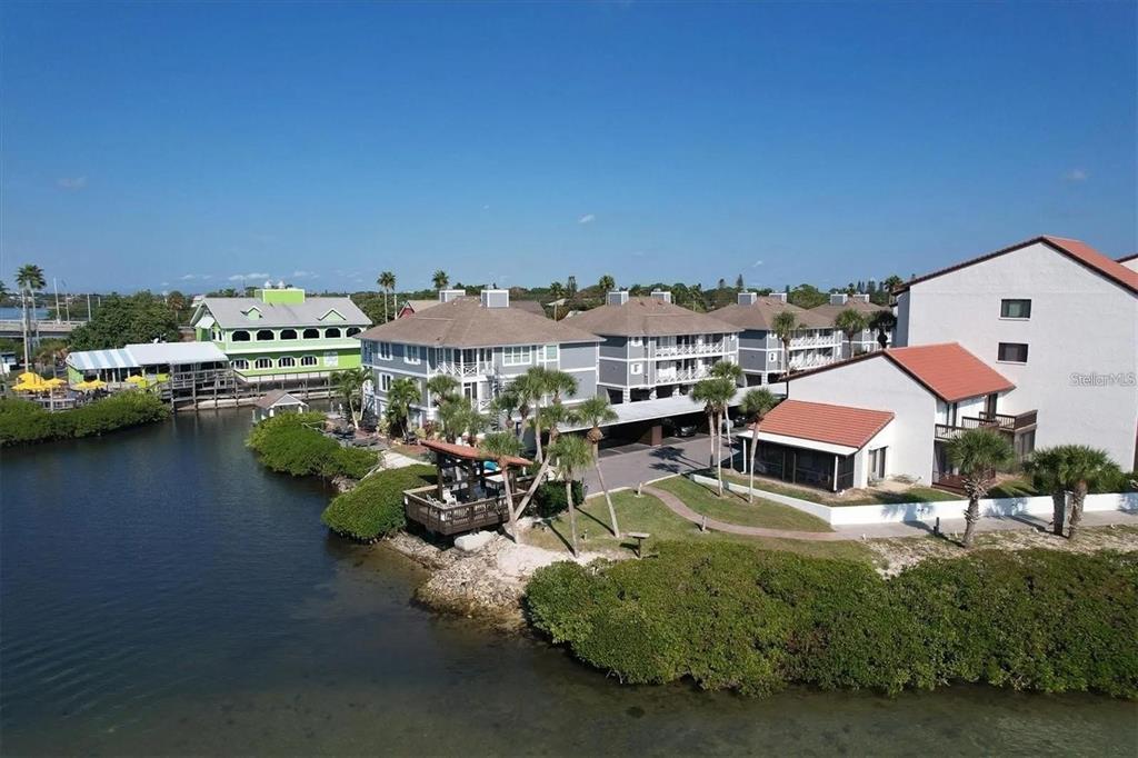 1624 Stickney Point Road, Unit 108 Sarasota, FL 34231 - Photo 22 of 39 a swimming pool with outdoor seating and yard