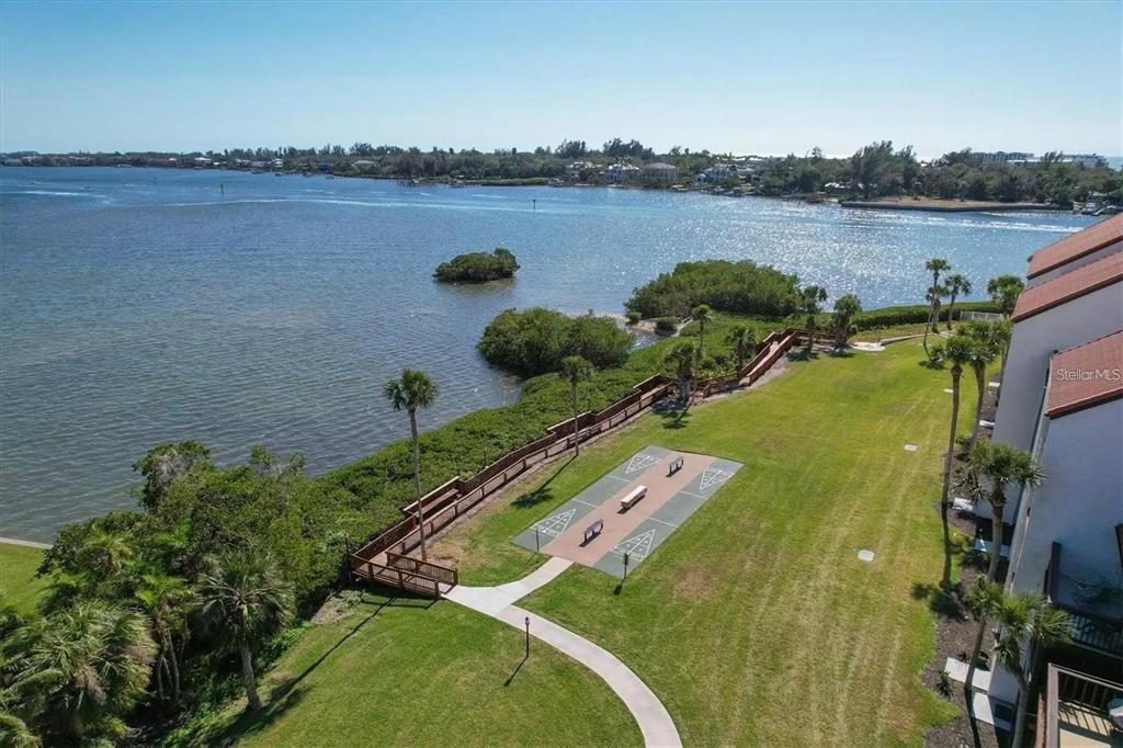 1624 Stickney Point Road, Unit 108 Sarasota, FL 34231 - Photo 29 of 39 a view of a lake with a city