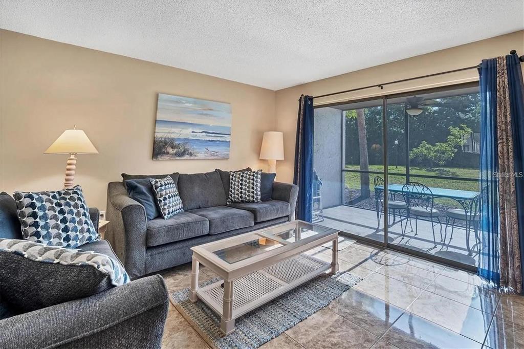 1624 Stickney Point Road, Unit 108 Sarasota, FL 34231 - Photo 3 of 39 a living room with furniture and a large window