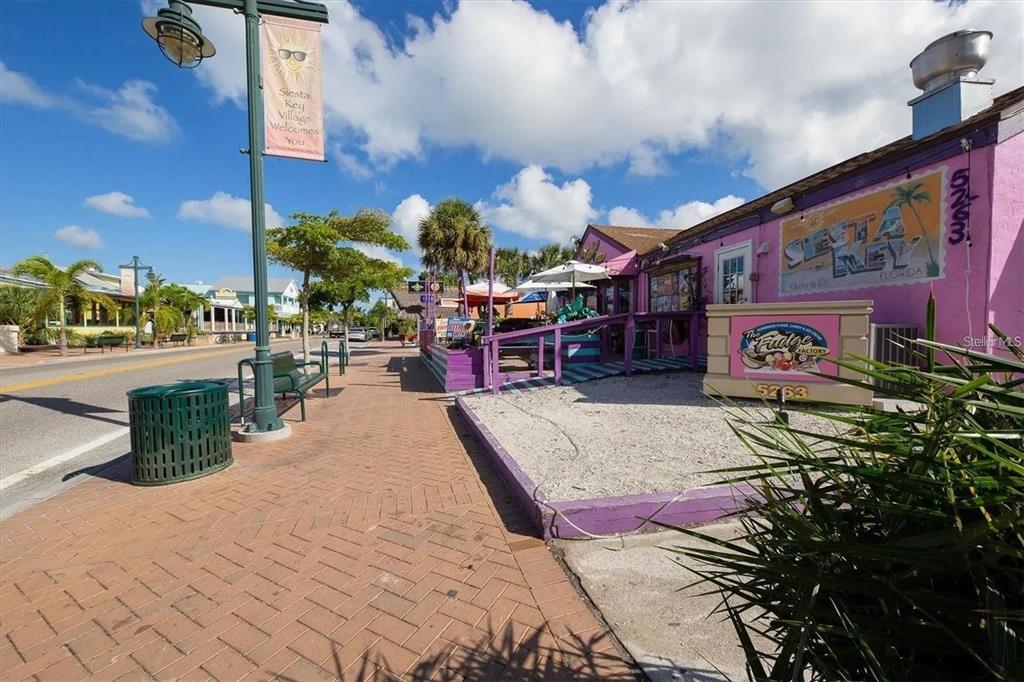 1624 Stickney Point Road, Unit 108 Sarasota, FL 34231 - Photo 39 of 39 a sign board with buildings in the background