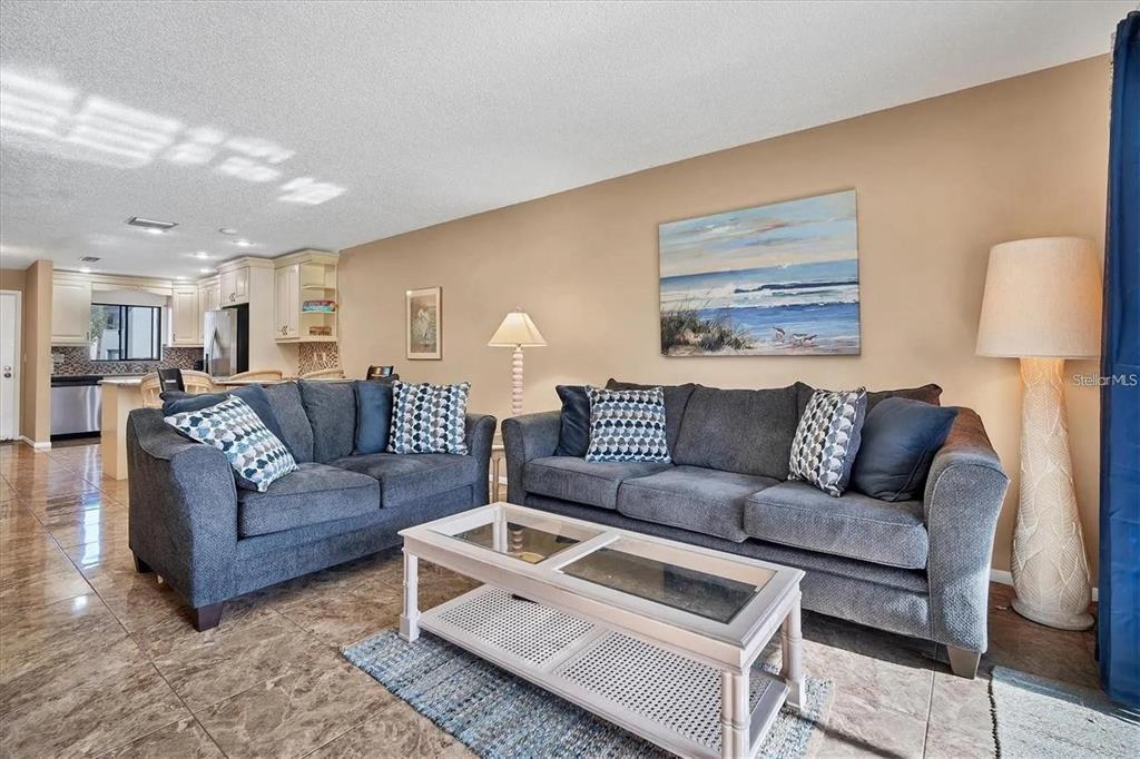 1624 Stickney Point Road, Unit 108 Sarasota, FL 34231 - Photo 5 of 39 a living room with furniture and a couch