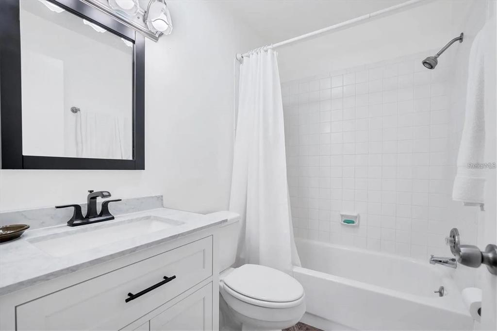1624 Stickney Point Road, Unit 108 Sarasota, FL 34231 - Photo 10 of 39 a bathroom with a sink a toilet and shower
