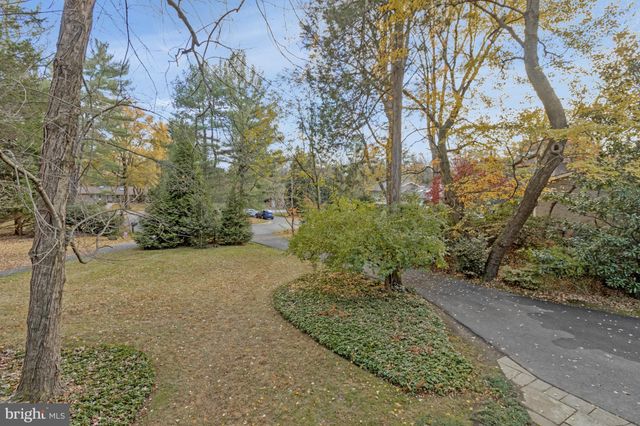 a living room with furniture a clock on wall and a window