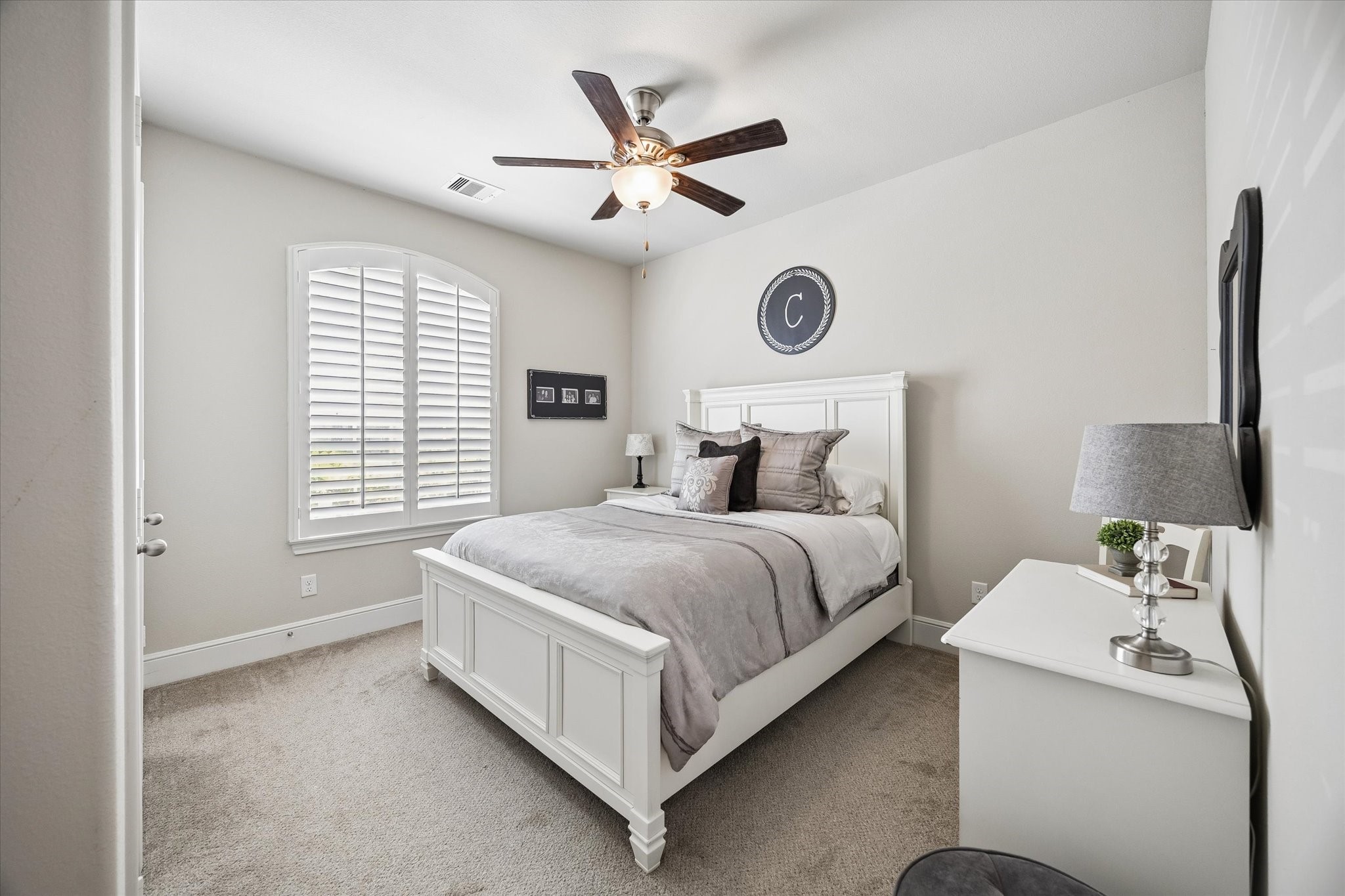 19 Peace Tree Way Tomball, TX 77375 - Photo 9 of 36 This secondary bedroom features plantation shutters and a view of the front yard.