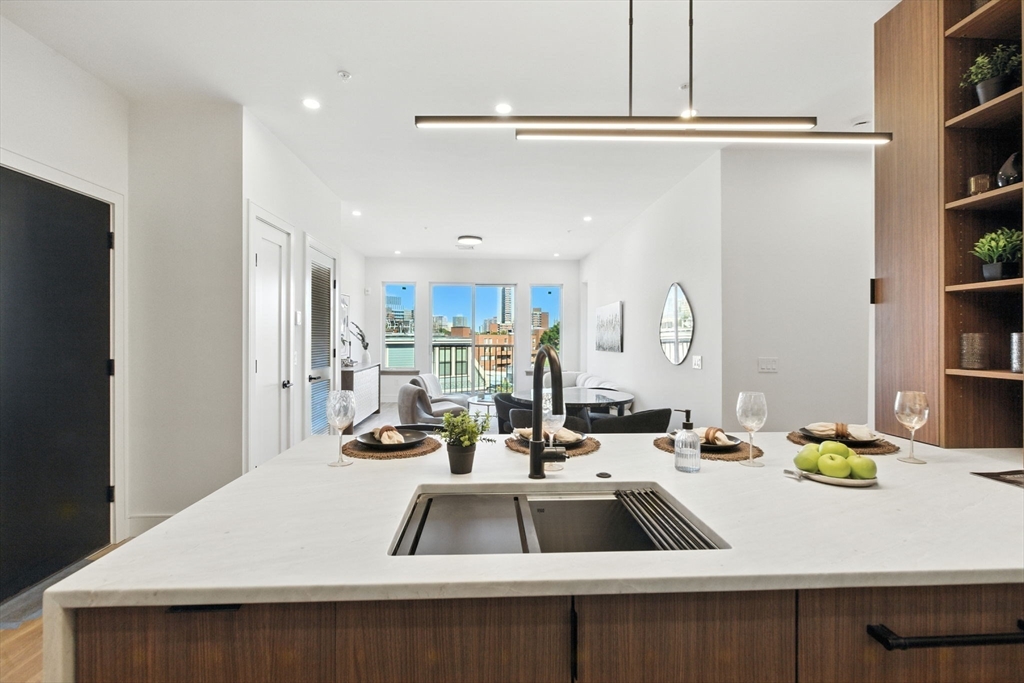 58 Kent, Unit 303 Brookline, MA 02445 - Photo 11 of 41 a kitchen with sink refrigerator and stove
