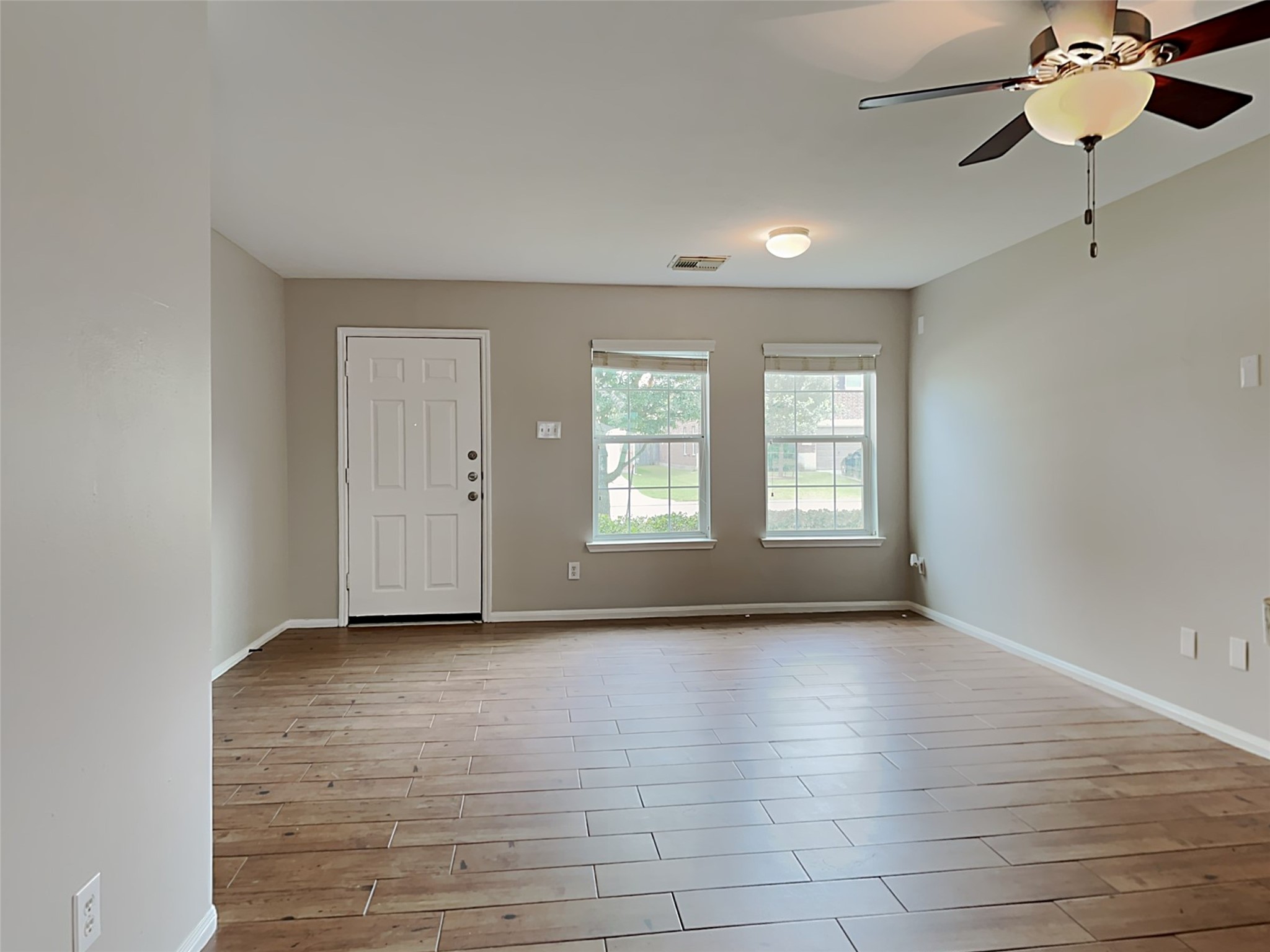 8119 Katie Mill Trail Spring, TX 77379 - Photo 9 of 18 a view of an empty room with a window and wooden floor