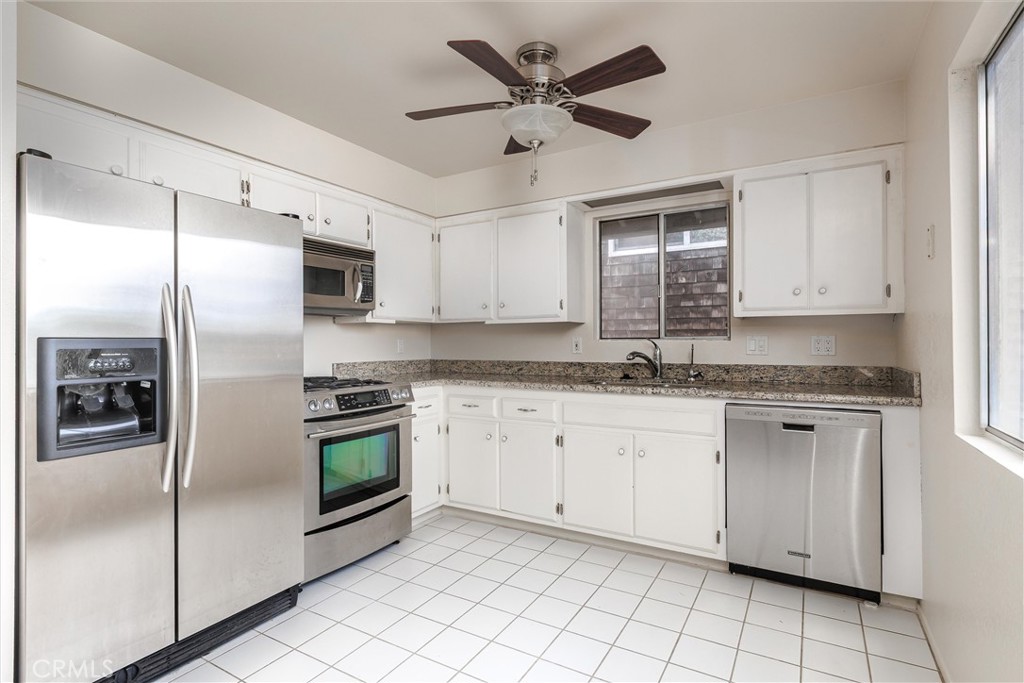 369 Dunbar Street Morro Bay, CA 93442 - Photo 8 of 22 a kitchen with granite countertop white cabinets white stainless steel appliances and a sink
