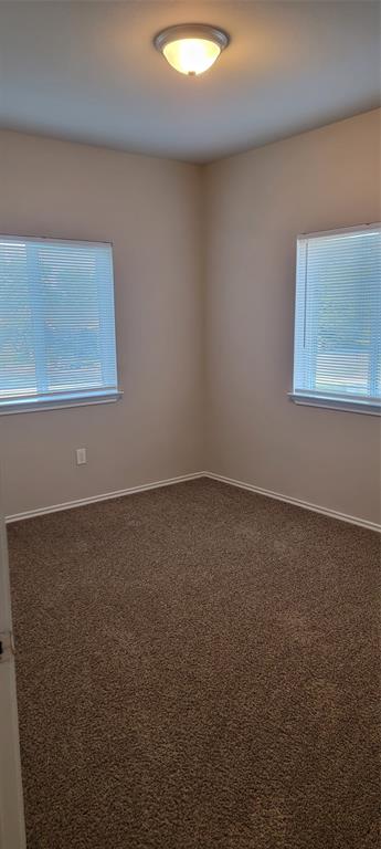 516 East Hazelwood Street, Unit A Princeton, TX 75407 - Photo 12 of 13 Bedroom 2 with baseboards and dark colored carpet