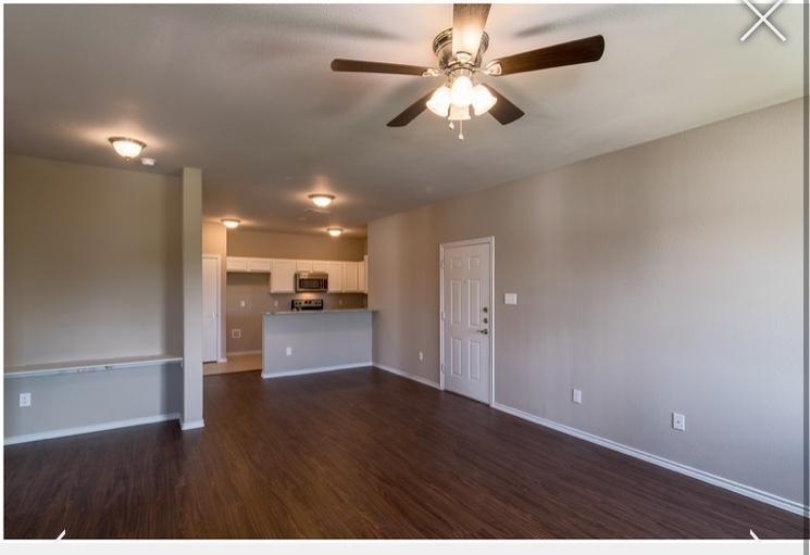 516 East Hazelwood Street, Unit A Princeton, TX 75407 - Photo 5 of 13 Unfurnished living room featuring dark wood-type flooring and a ceiling fan