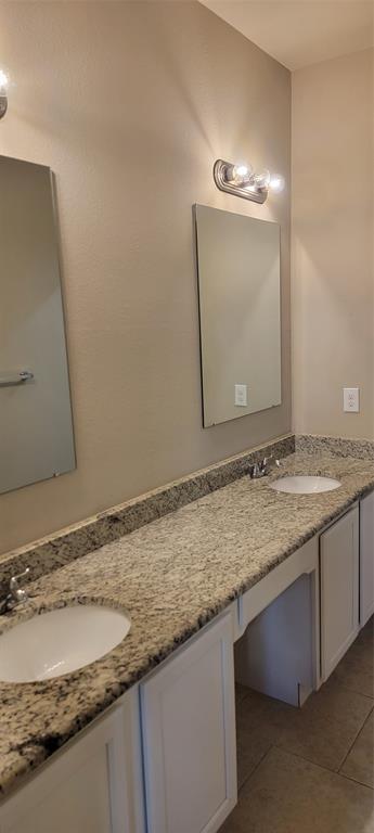 516 East Hazelwood Street, Unit A Princeton, TX 75407 - Photo 9 of 13 Bathroom with double vanity and light tile patterned floors