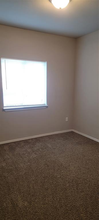 516 East Hazelwood Street, Unit A Princeton, TX 75407 - Photo 10 of 13 Bedroom 1 featuring carpet flooring and baseboards