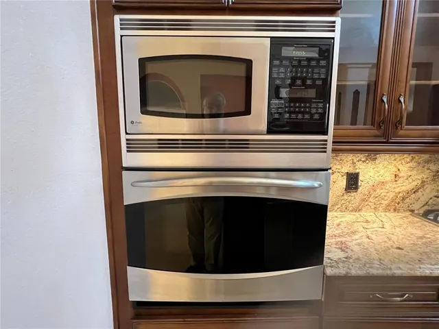 a stove top oven sitting inside of a kitchen