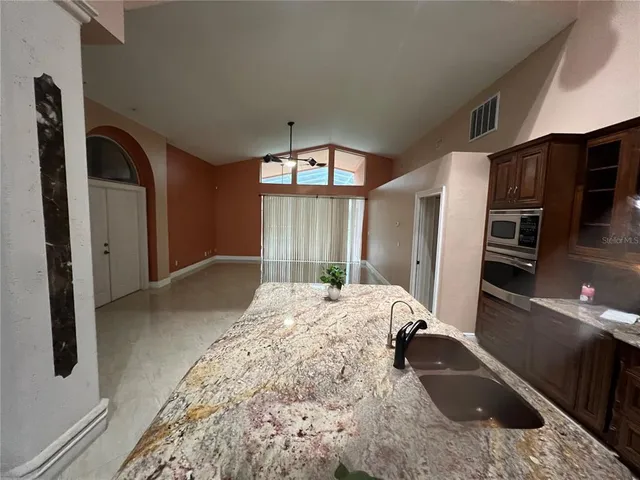 a large bedroom with a bed and a large mirror on the dresser