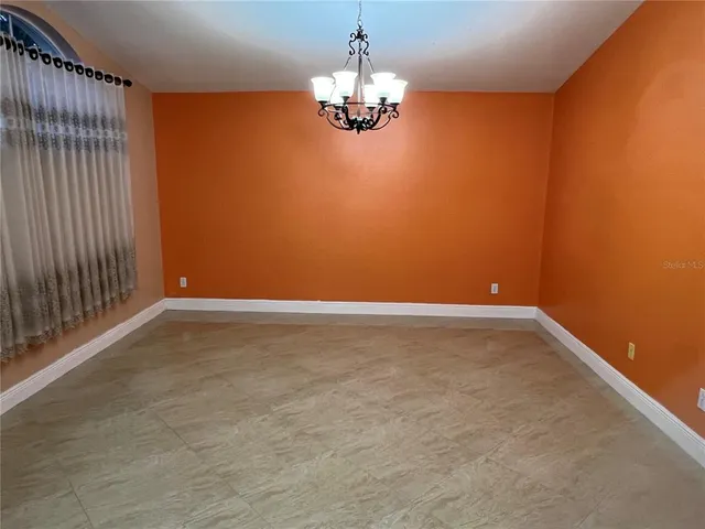 a view of a chandelier fan and hardwood floor