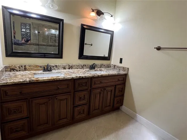 a bathroom with a double vanity sink and a mirror