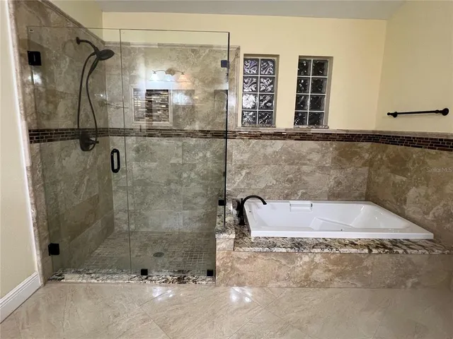 a bathroom with a shower and a sink