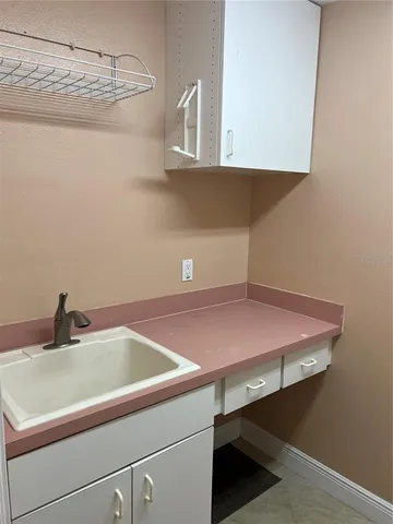 a bathroom with a sink and cabinets