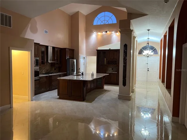 a kitchen with stainless steel appliances a refrigerator and a sink
