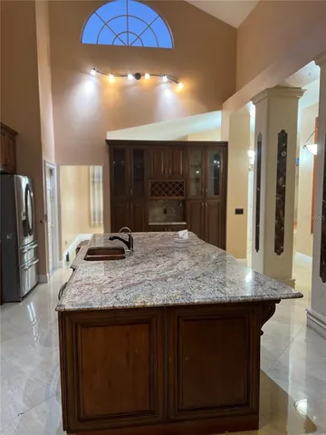 a view of a kitchen counter top space a sink cabinets and stainless steel appliances