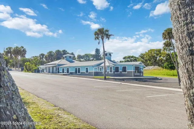 a view of a workspace with furniture and wooden floor
