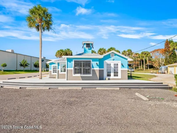 a view of a workspace with furniture and wooden floor