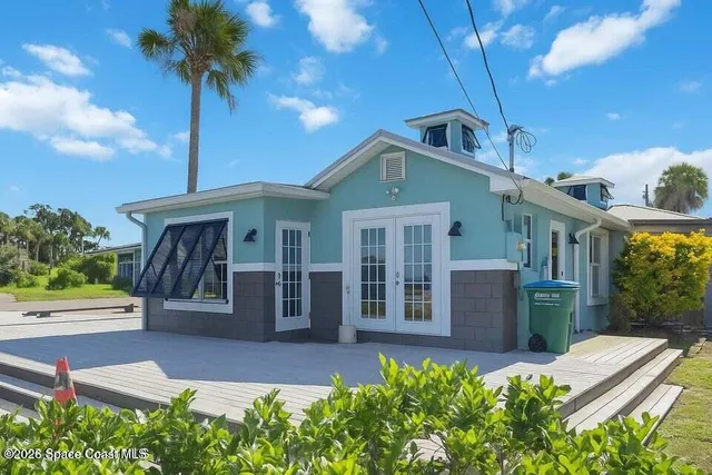 a living room with furniture and a mirror