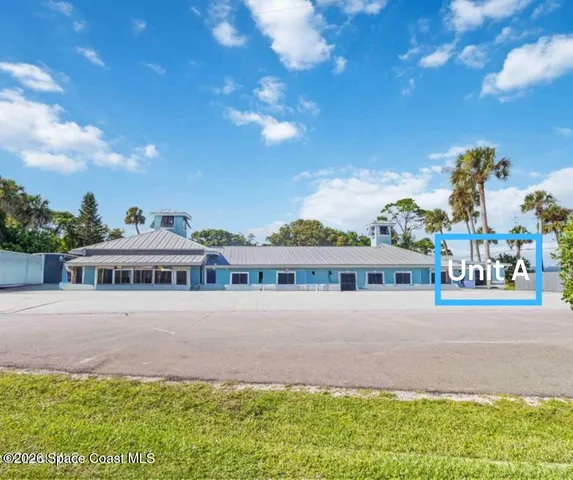 a view of a hallway with workspace and a window