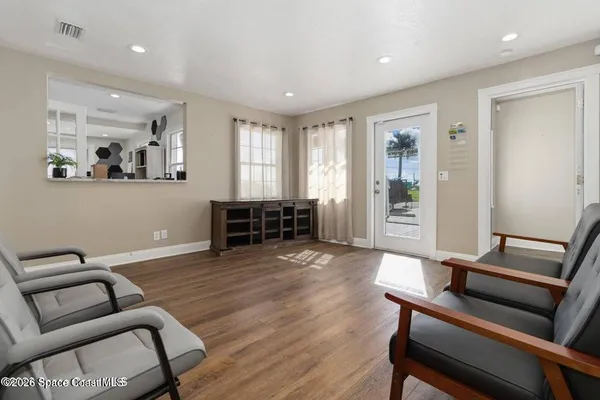 a living room with furniture and kitchen view