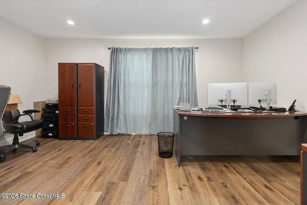 a kitchen with granite countertop a sink a stove cabinets and entryway