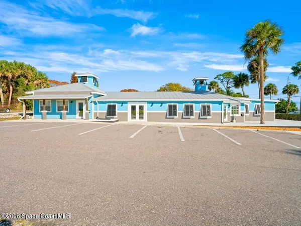 a view of a living room with kitchen island granite countertop wooden floor and a view of living room