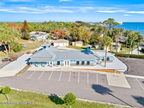 a view of a city with an ocean and a building