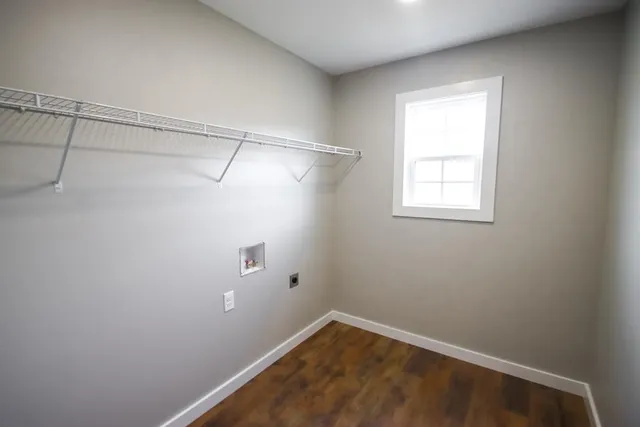 a view of a small space with wooden floor and windows
