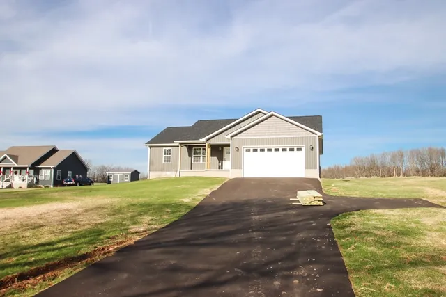 a view of a house with beach and ocean view