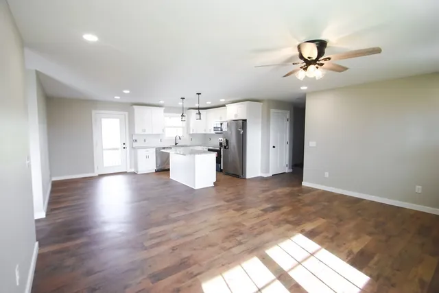 a view of a kitchen with a dishwasher cabinets and wooden floor
