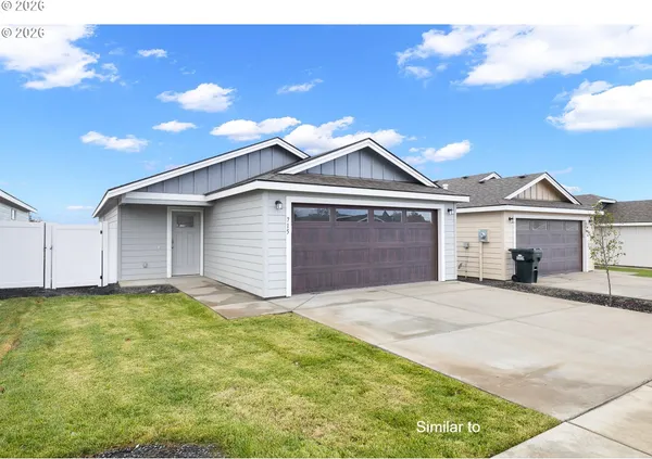a view of a house with a yard and garage