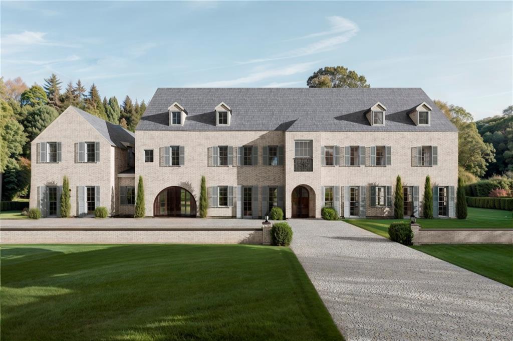 a front view of a residential apartment building with a yard