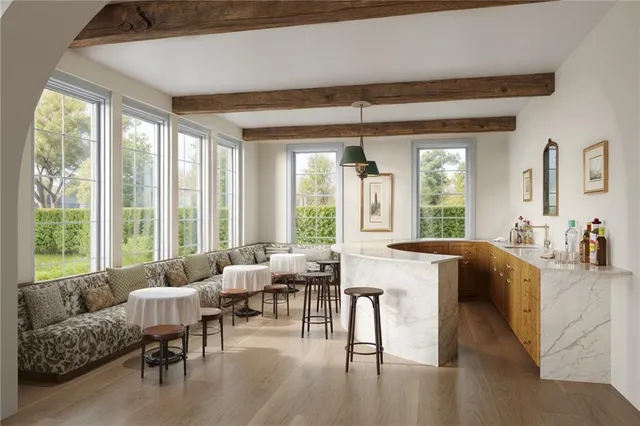 a living room with furniture and large windows