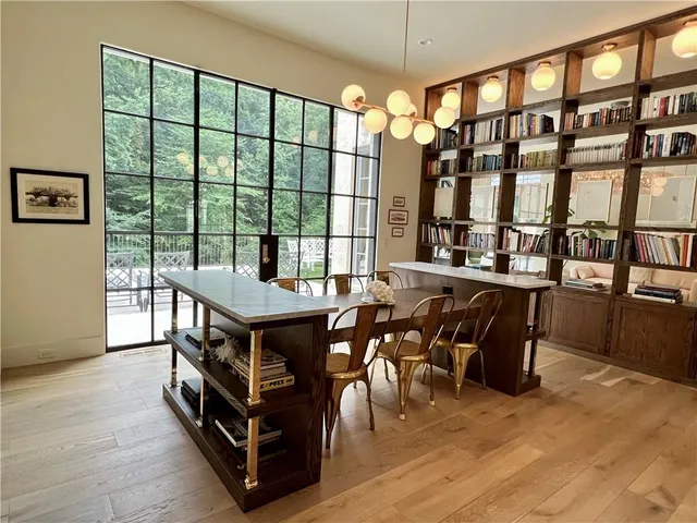 a room with lots of wooden furniture and a table
