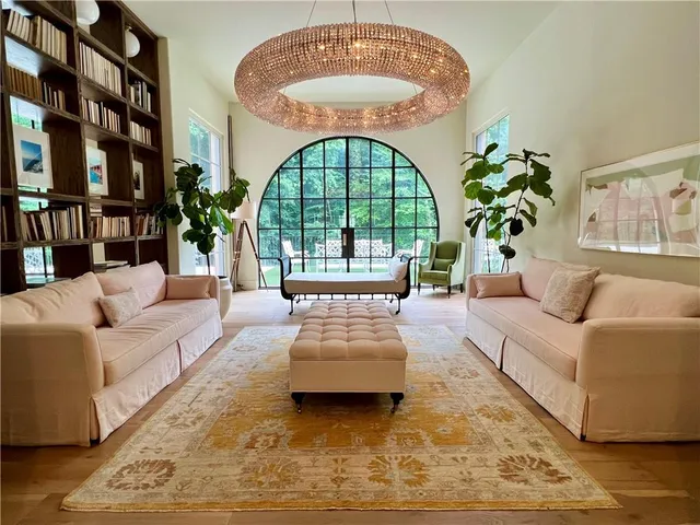a living room with a couch and a chandelier