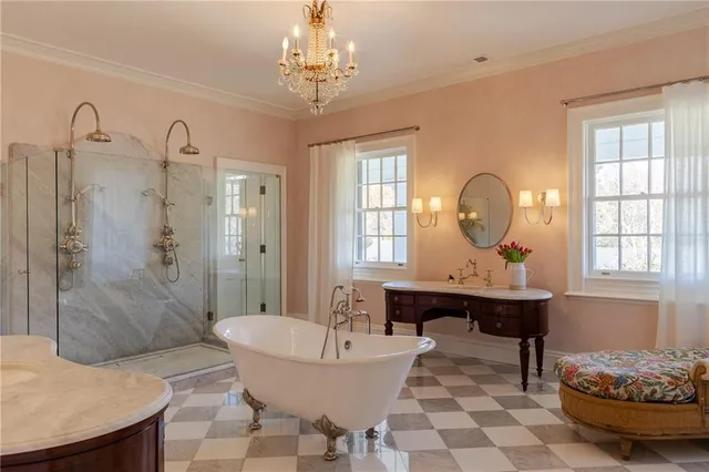 a spacious bathroom with a shower a sink and a mirror