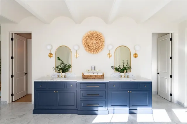 a room with a potted plant on the dresser and a table