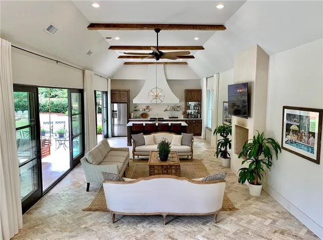 a living room with furniture and a chandelier