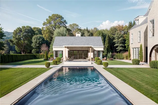 a view of a house with swimming pool and a yard